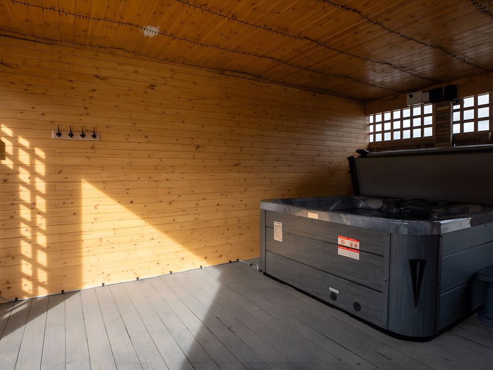 An indoor space with a hot tub and wooden walls at The Galloway in Morpeth