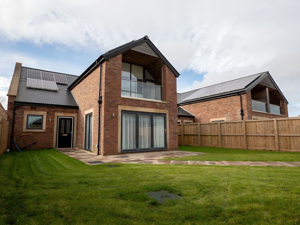 A house with solar panels and a lawn at The Galloway in Morpeth