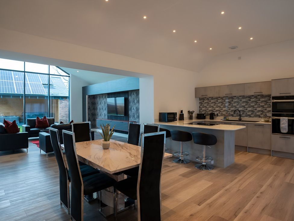 A kitchen with a dining table and seating area at The Shearling in Morpeth