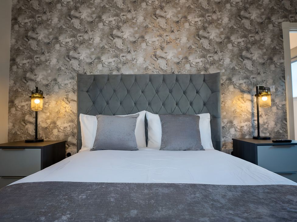 A bedroom with a bed and bedside tables at The Shearling in Morpeth