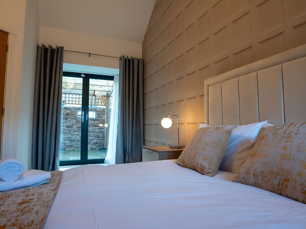 A bedroom with a bed and access to an outdoor area at The Shearling in Morpeth