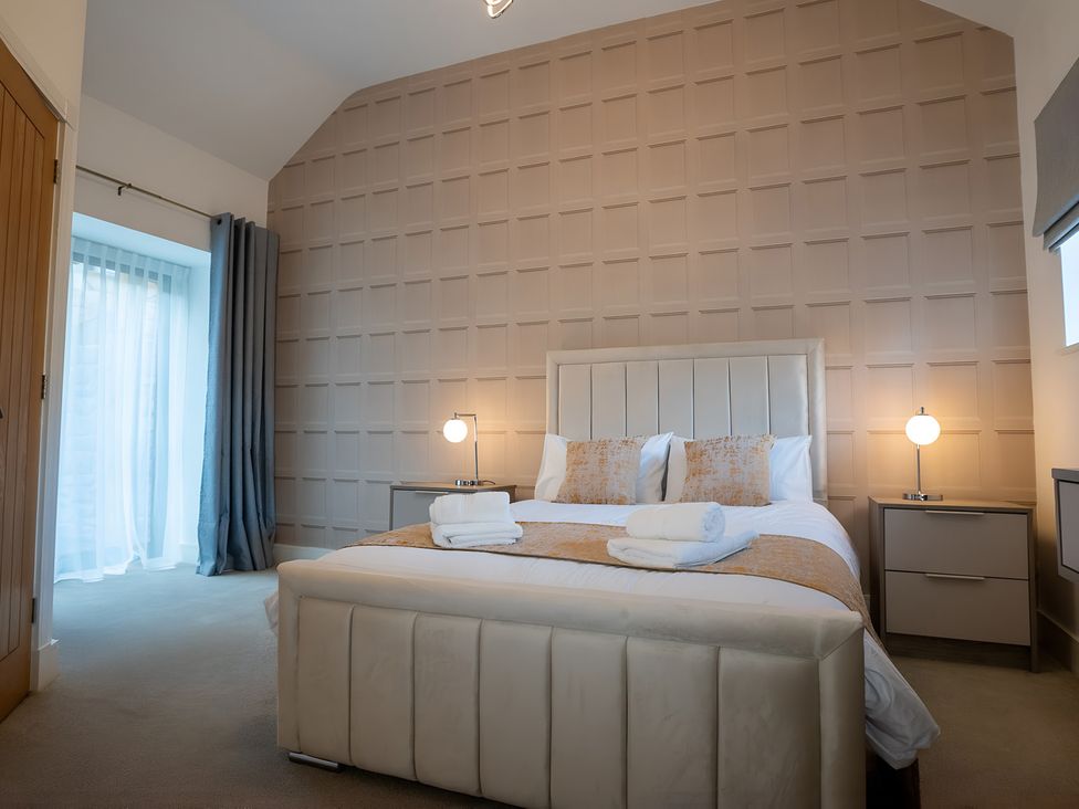 A bedroom with a bed and bedside tables at The Shearling in Morpeth