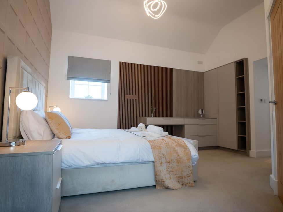 A bedroom with a bed and a nightstand at The Shearling in Morpeth