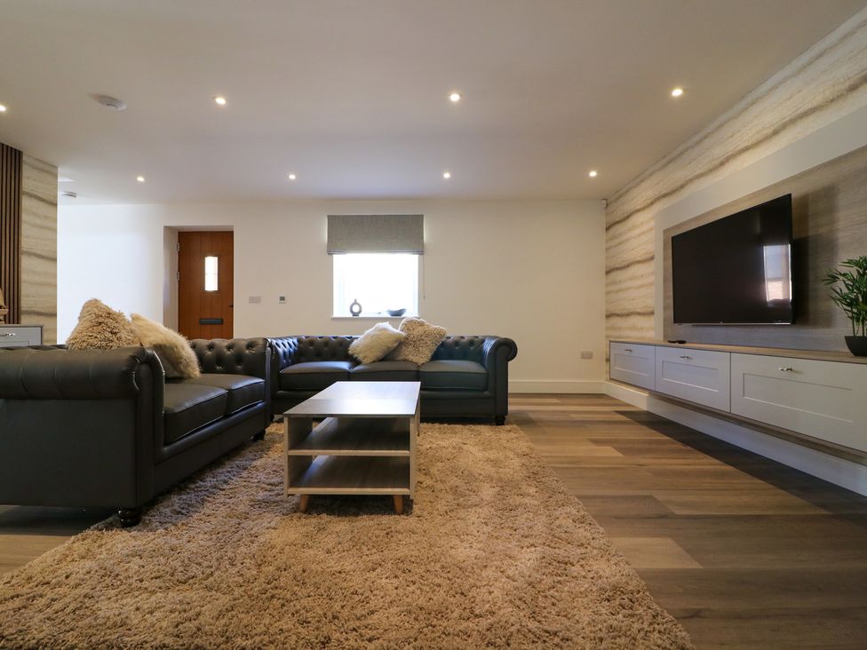 A living room with a sofa and television at The Newland in Morpeth