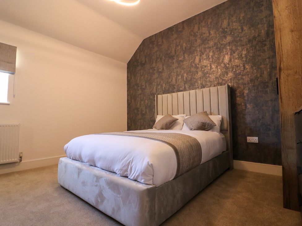 A bedroom with a bed and window at The Newland in Morpeth