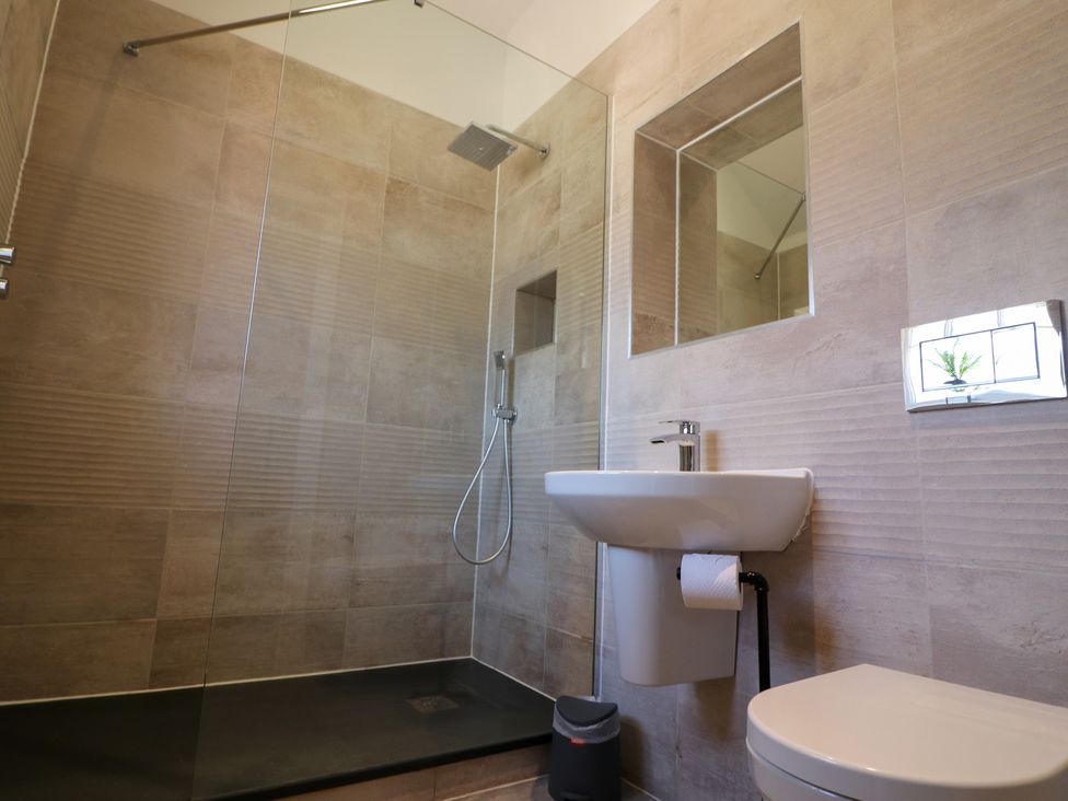 A bathroom featuring a shower, sink, and toilet at The Newland in Morpeth