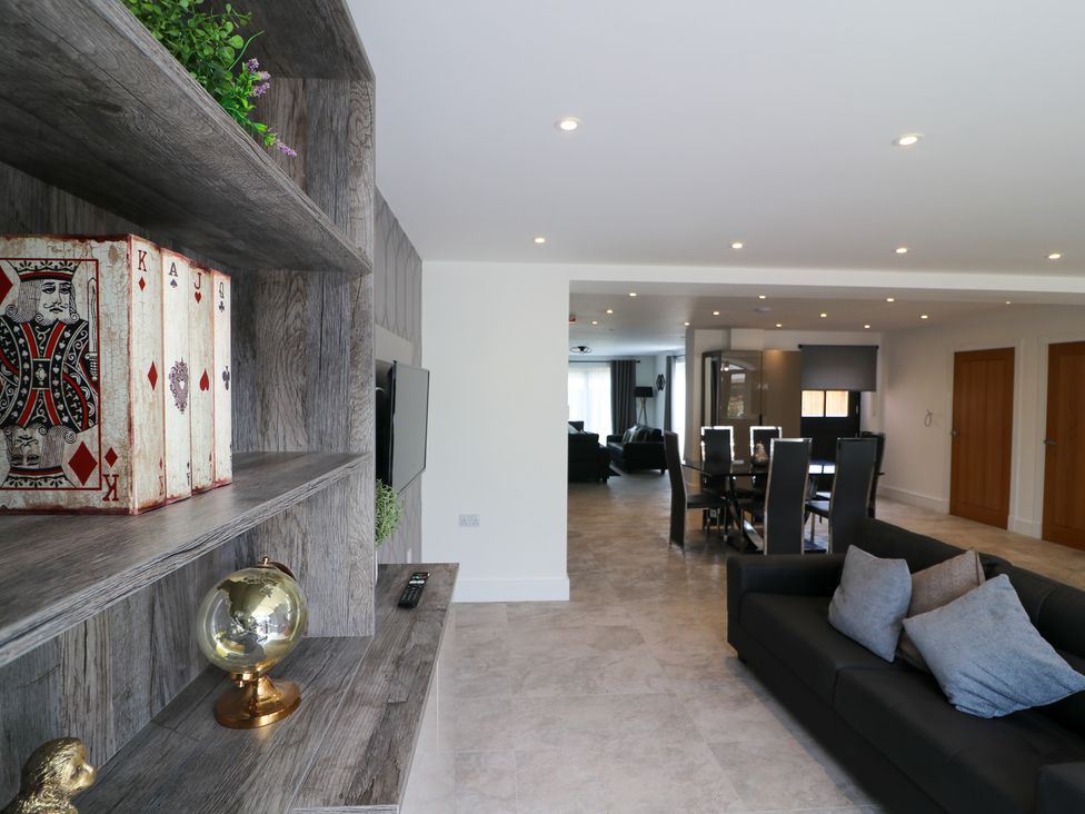 A living room with a television and dining area at The Gavel in Morpeth