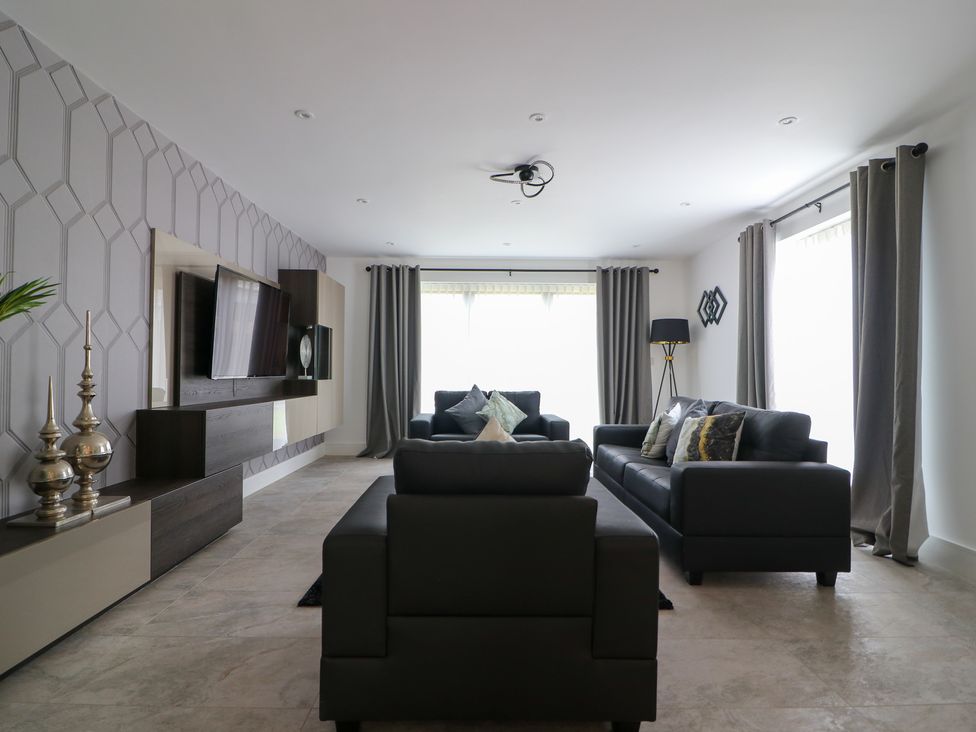 A living room with a television and sofas at The Gavel in Morpeth