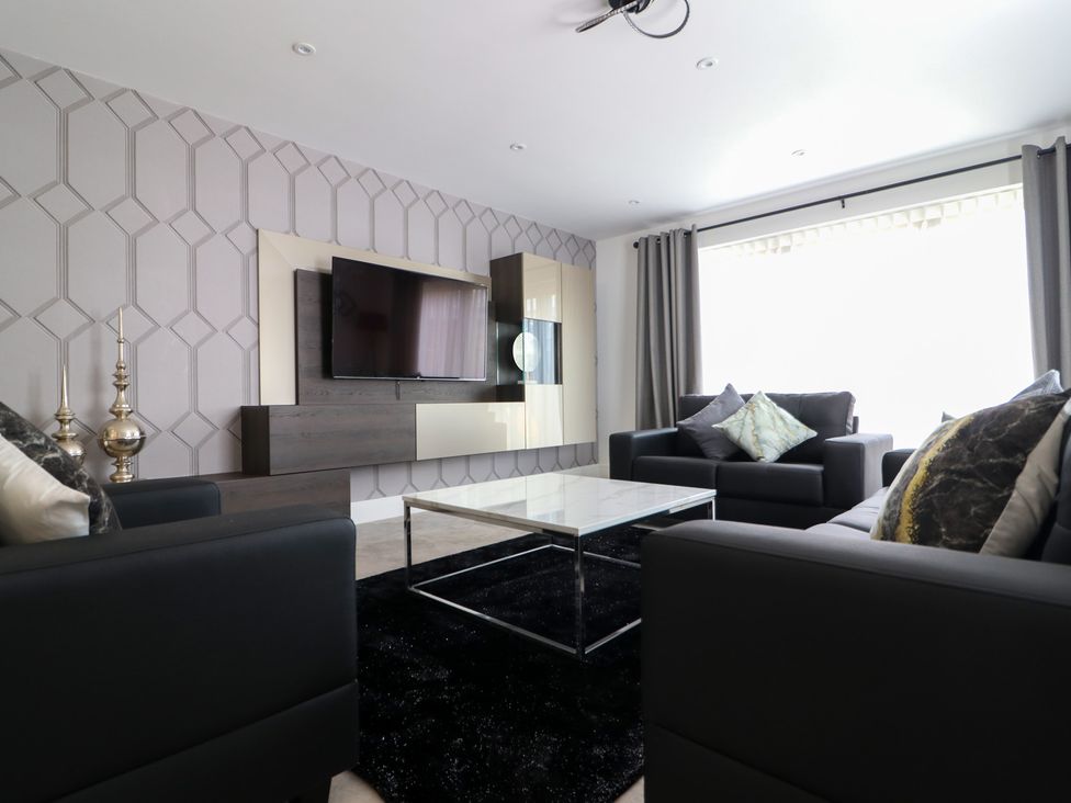 A living room with a television and coffee table at The Gavel in Morpeth