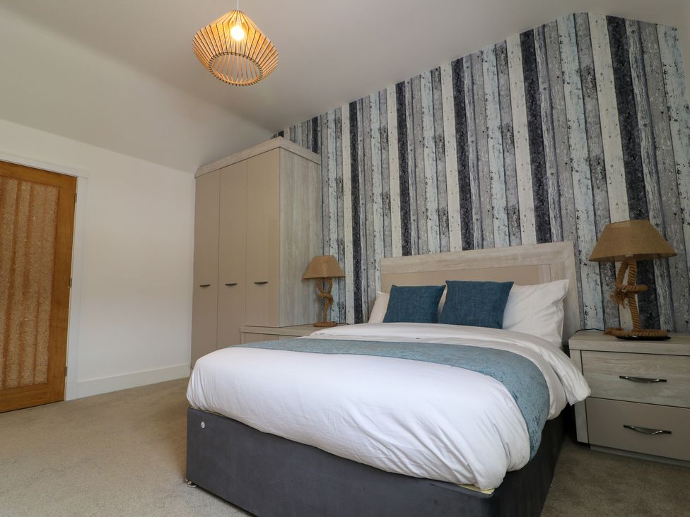 A bedroom with a bed and wardrobe at The Gavel in Morpeth
