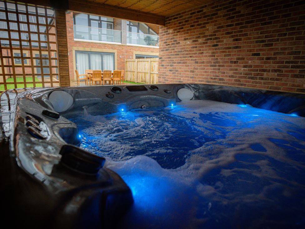 A hot tub with bubbling water and lights at The Gavel in Morpeth