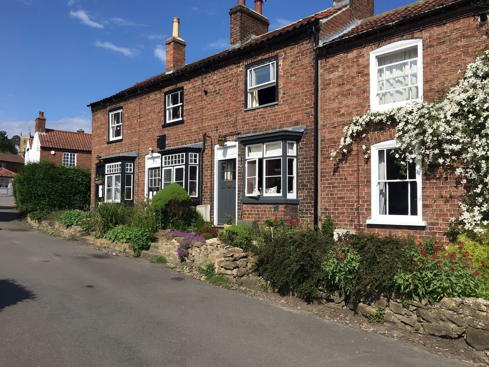A row of brick houses with gardens at 29 Front Street Market Rasen