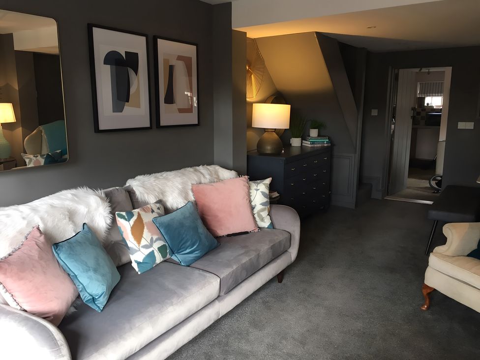 A living room with a sofa and decorative pillows at 29 Front Street in Market Rasen