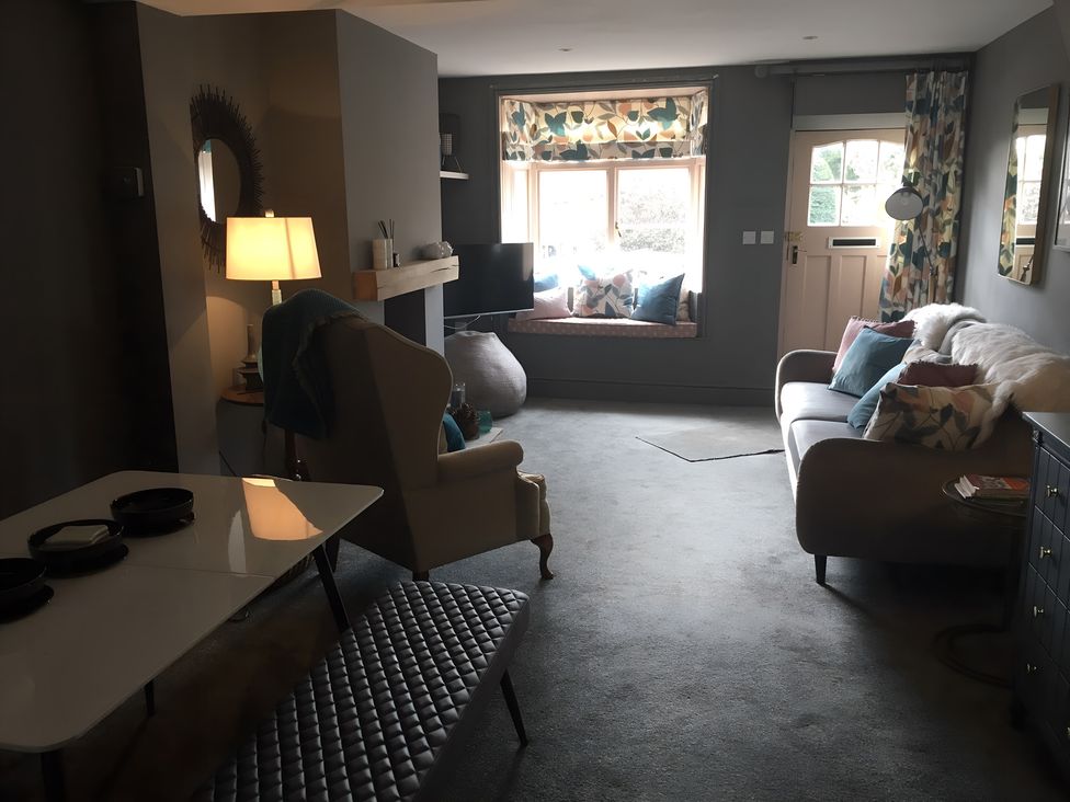 A living room with a sofa and television at 29 Front Street in Market Rasen
