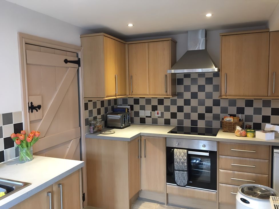 A kitchen with cabinets and cooking appliances at 29 Front Street in Market Rasen