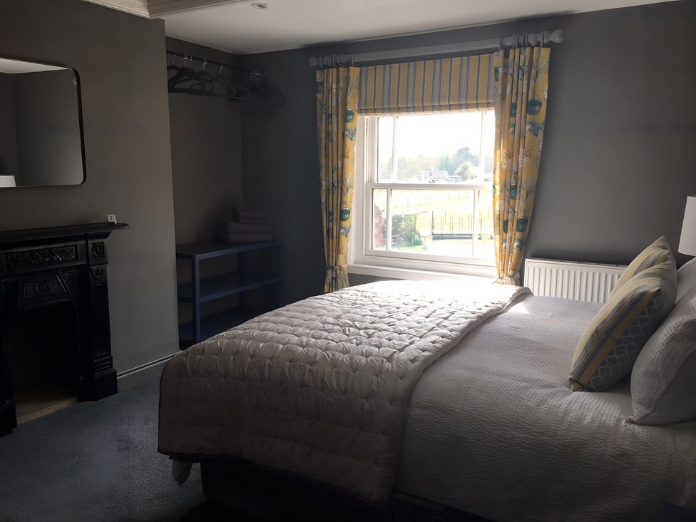 A bedroom with a bed and a window at 29 Front Street, Market Rasen