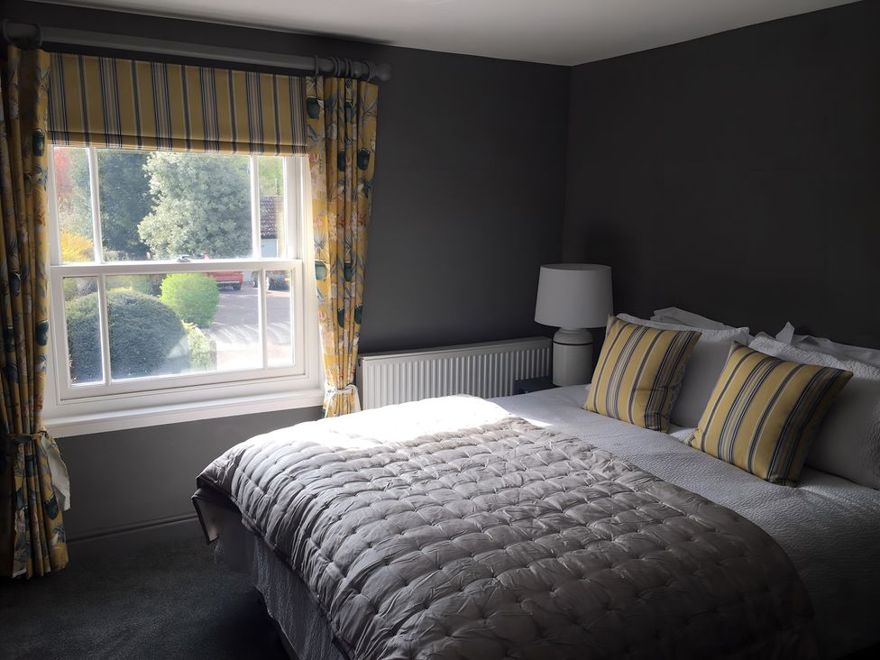 A bedroom with a bed and lamp at 29 Front Street in Market Rasen