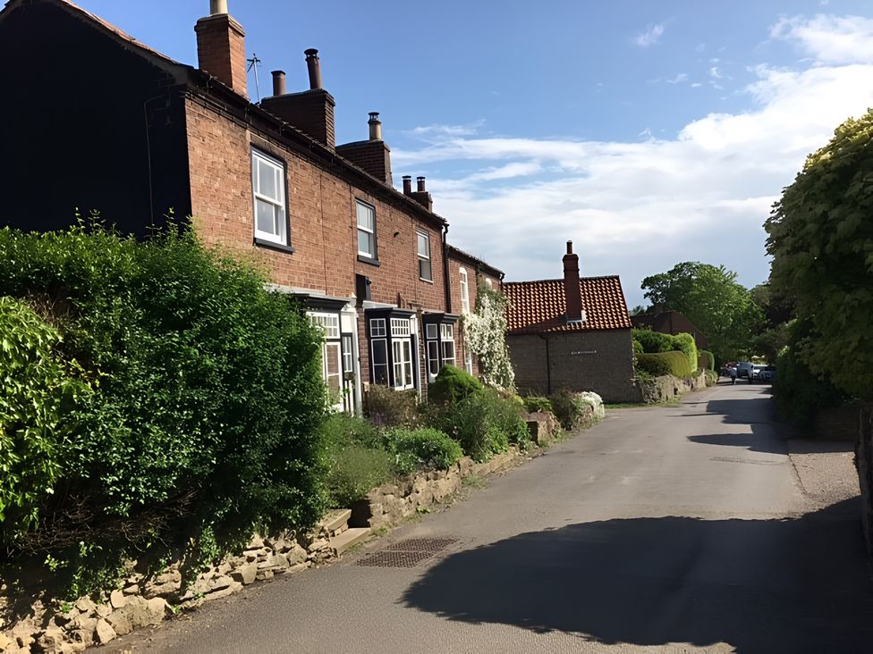 A street view with houses and greenery at 29 Front Street in Market Rasen