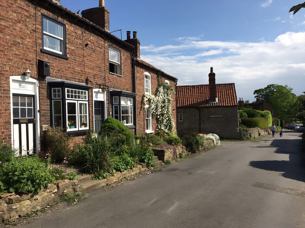 Brick houses with flowers along the pathway at 29 Front Street Market Rasen