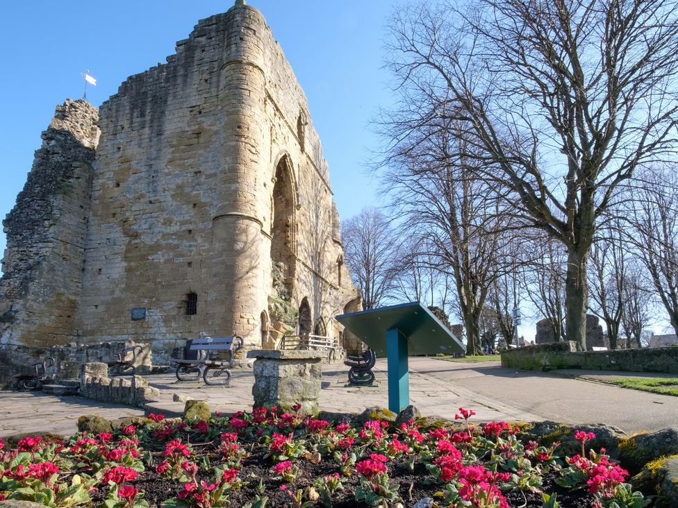 Ruins with flower bed and benches at an outdoor location