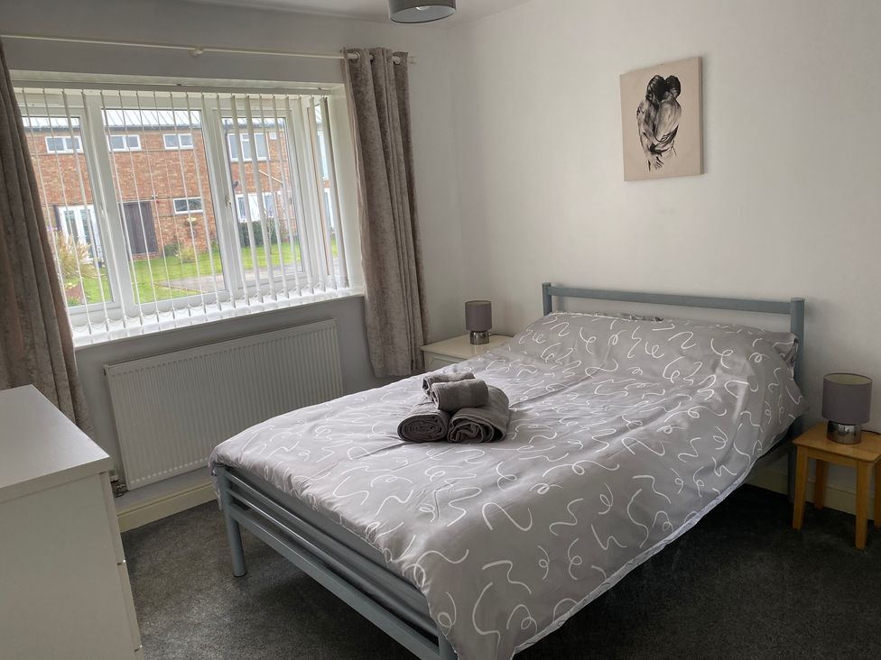 A bedroom with a bed and window at 19 Carnaby Mews in Bridlington