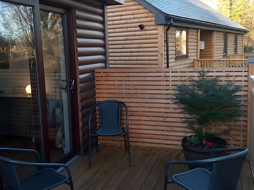 An outdoor area with chairs and a planter at Gowrie Lodge Blairgowrie