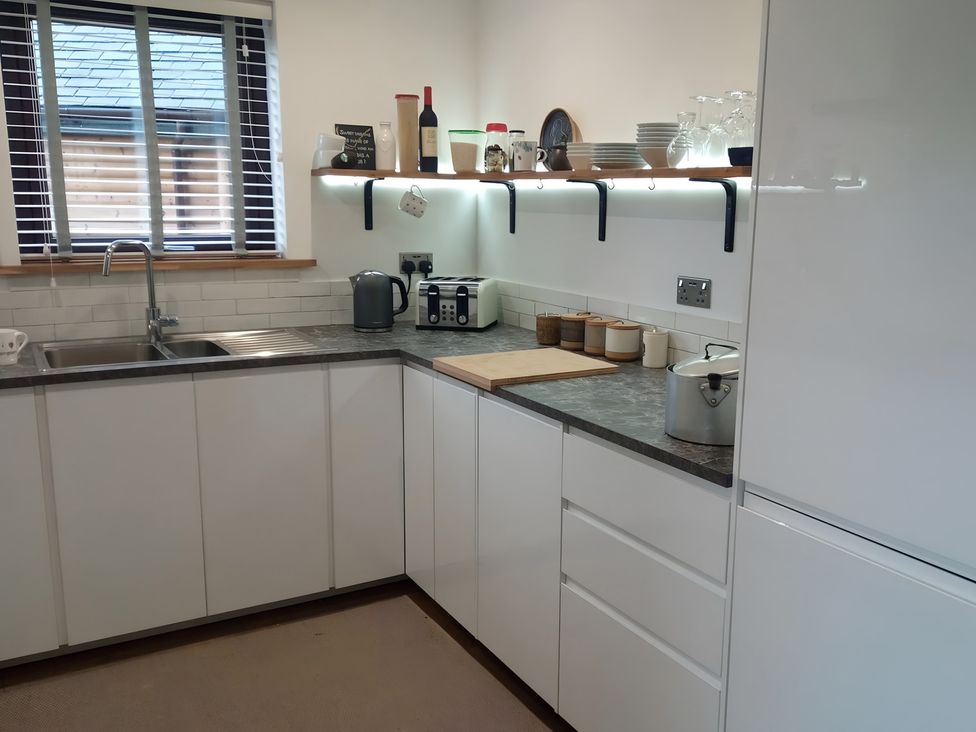 A kitchen with a sink, countertops, and appliances at Gowrie Lodge in Blairgowrie