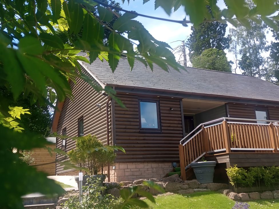 A house with a deck and garden at Gowrie Lodge in Blairgowrie
