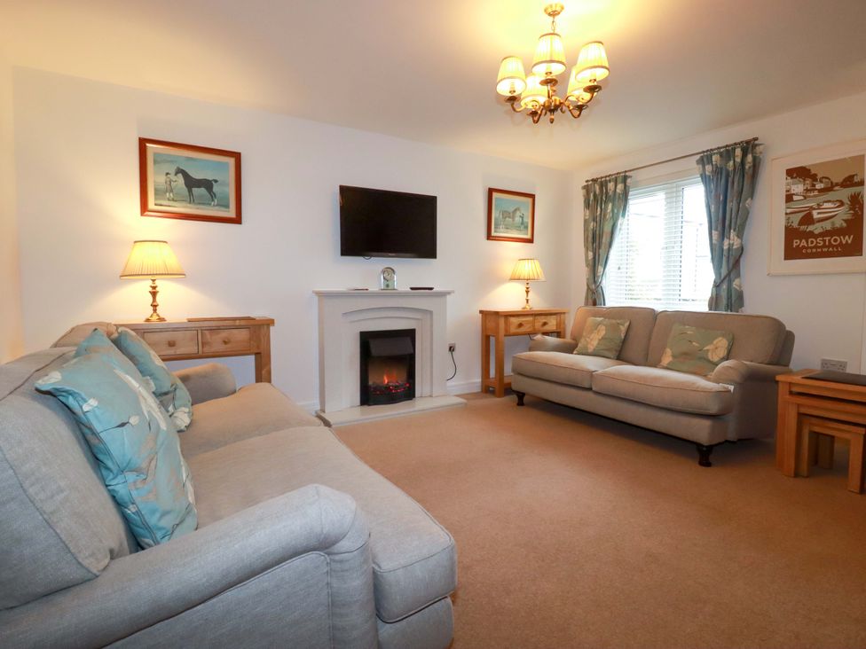 A living room with a television and sofa at 21 Greenwix Parc 