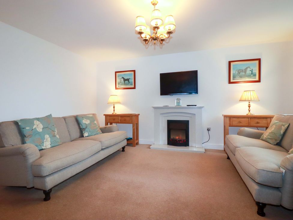 A living room with sofas and a television at 21 Greenwix Parc