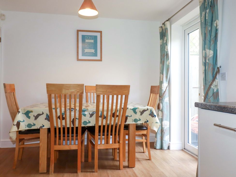 A dining room with a wooden table and chairs at 21 Greenwix Parc