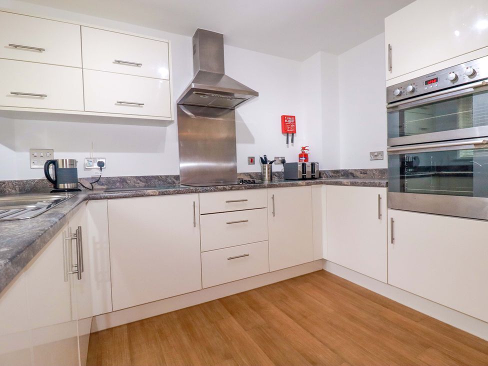 A kitchen with an oven, stove, sink and kettle at 21 Greenwix Parc