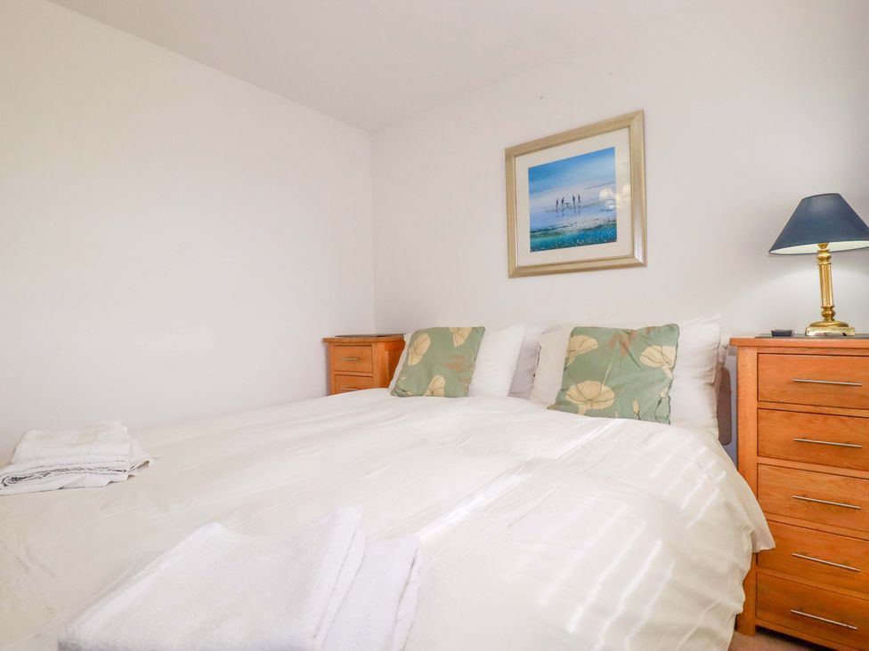 A bedroom with a bed and nightstand at 21 Greenwix Parc