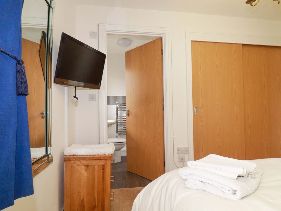 A bedroom with a television and bed at 21 Greenwix Parc