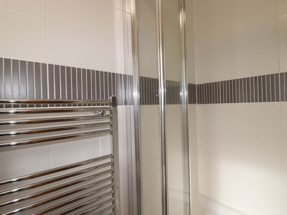 A bathroom with a shower and towel radiator at 21 Greenwix Parc