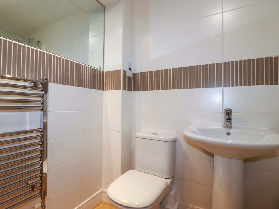 A bathroom with a toilet and sink at 21 Greenwix Parc