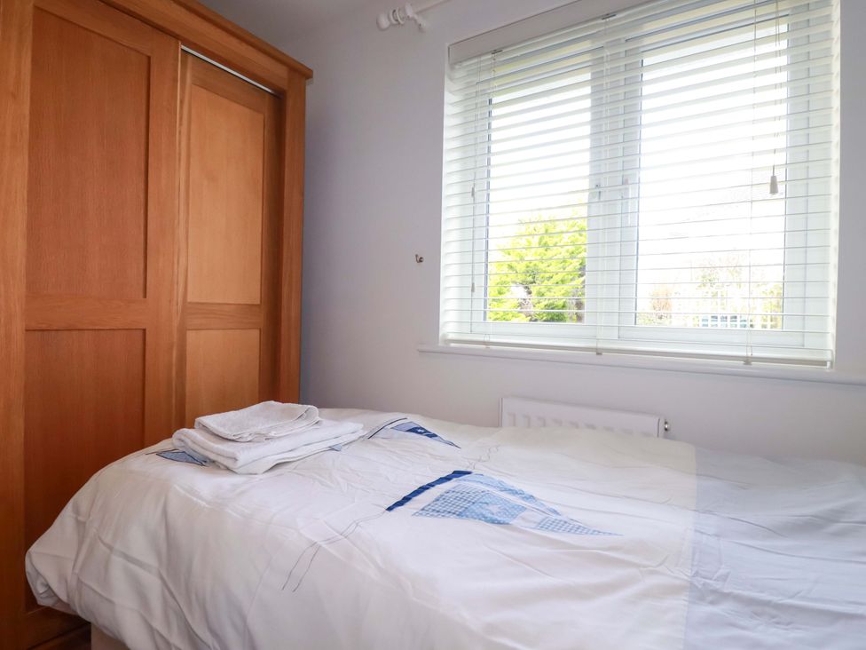 A bedroom with a bed and wardrobe at 21 Greenwix Parc