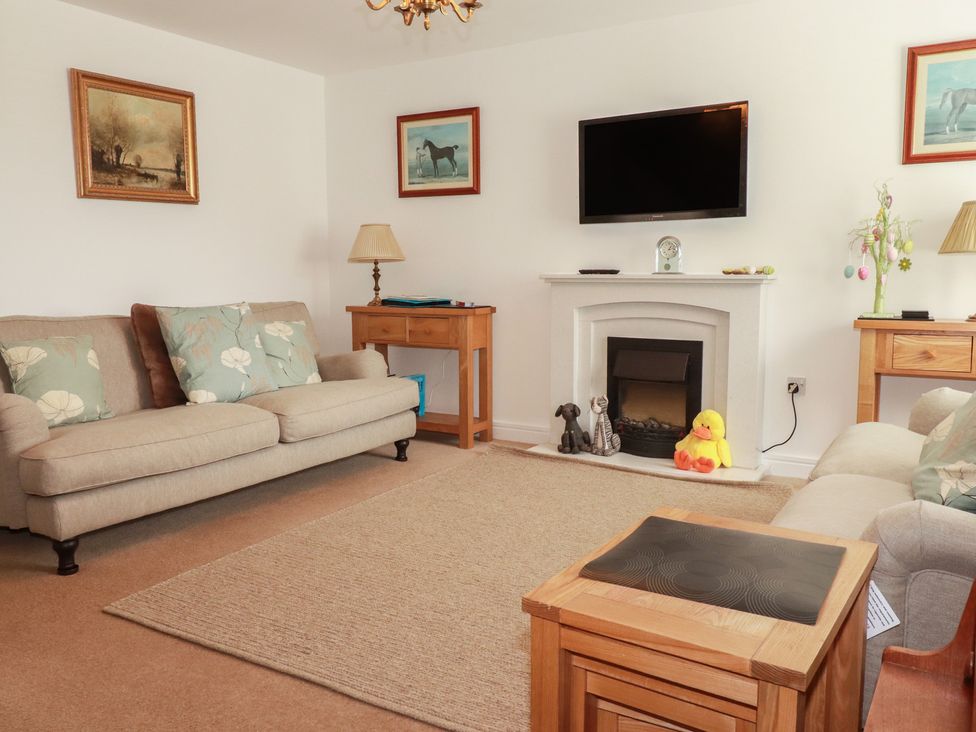 A living room with a TV and sofas at Treveline in St Mabyn