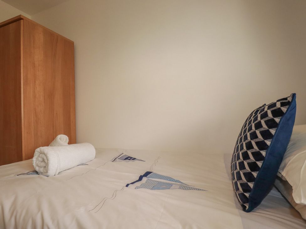 A bed with a towel and pillow at Treveline in St Mabyn
