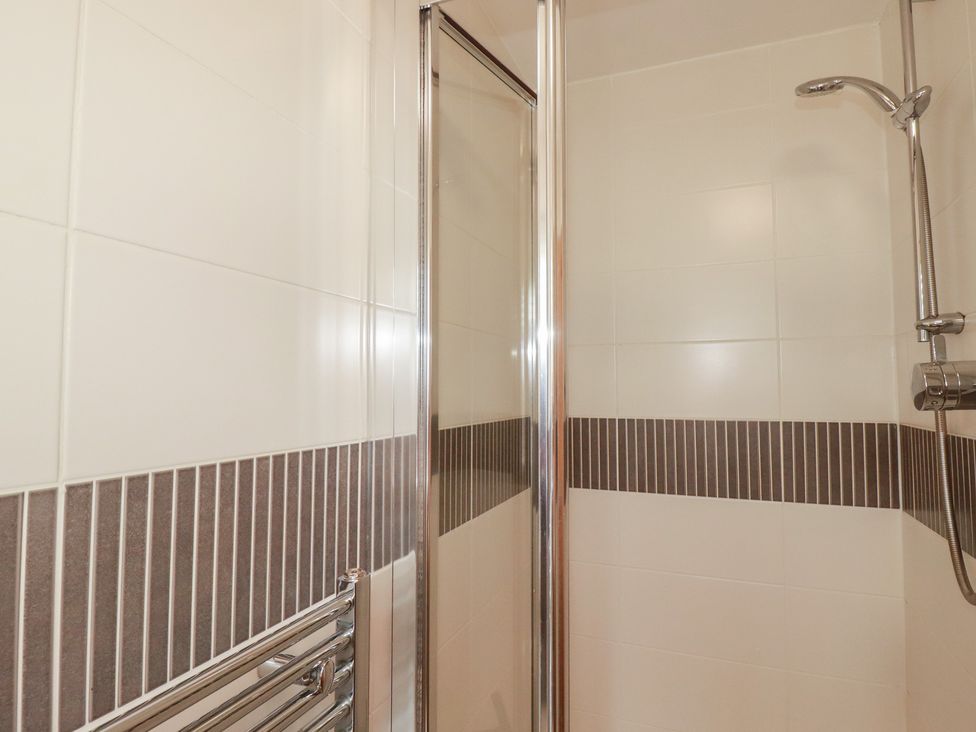 A shower with tiled walls at Treveline in St Mabyn