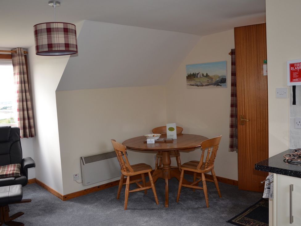 A dining room with a table and chairs at Oran Na Mara Achnasheen