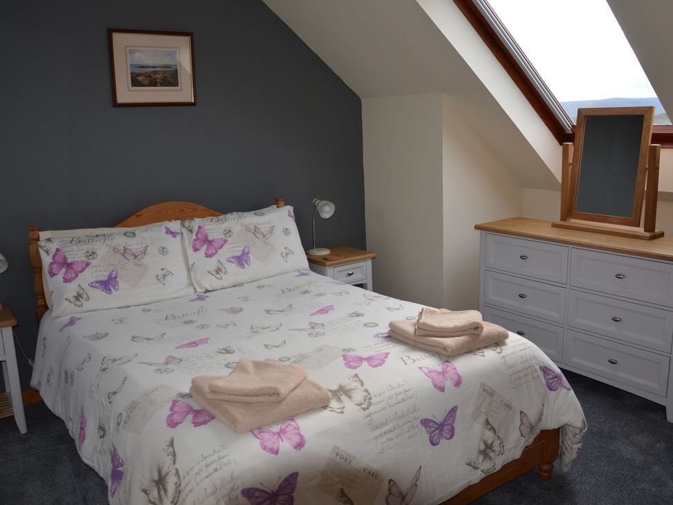 A bedroom with a bed and dresser at Oran Na Mara, Achnasheen