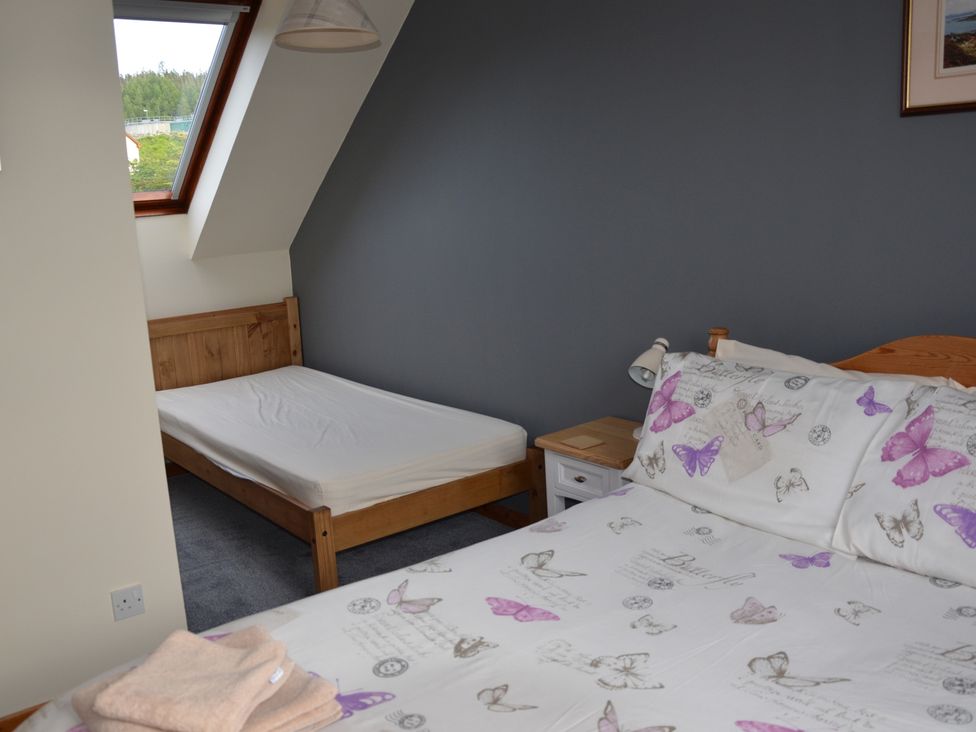 A bedroom with a double bed and a single bed at Oran Na Mara Achnasheen