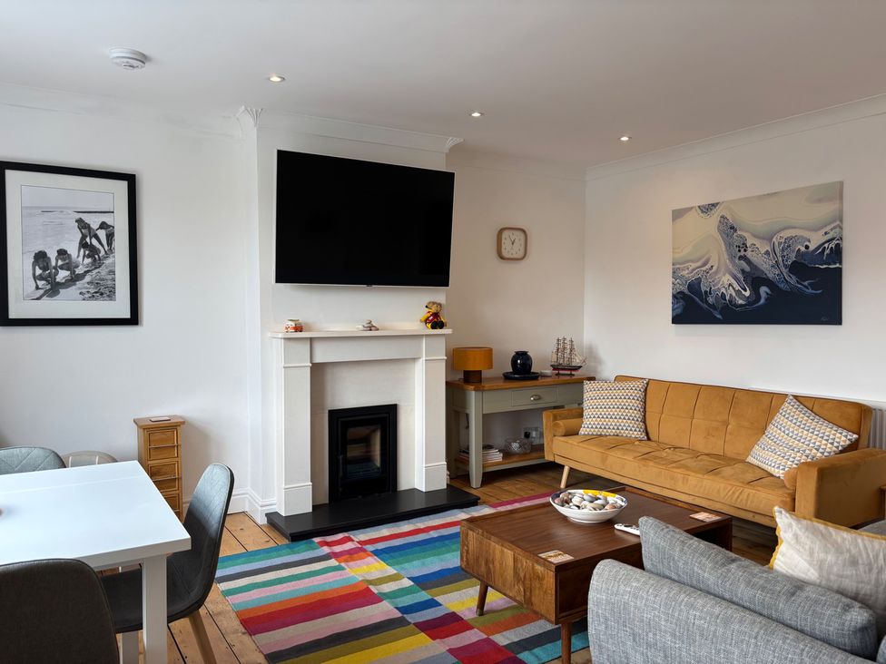 A living room with a sofa and coffee table at Edal Court in Sheringham
