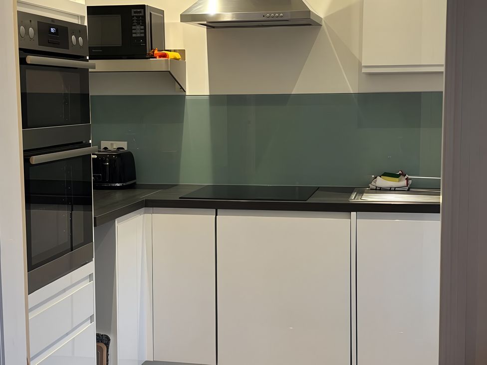 A kitchen with appliances and countertops at Edal Court in Sheringham