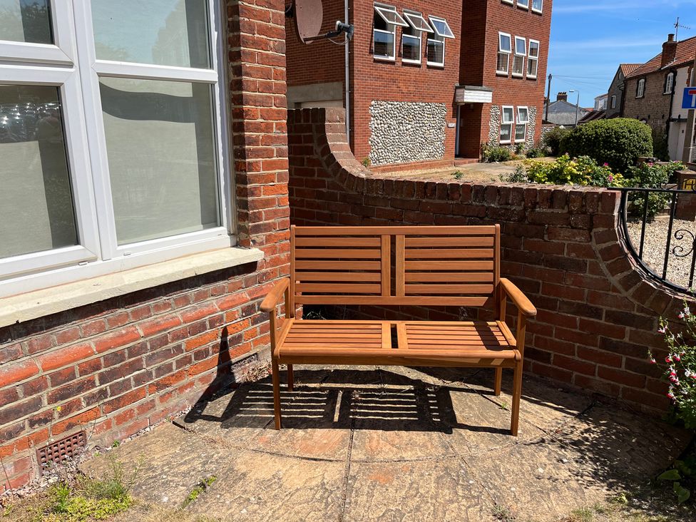 A wooden bench in an outdoor area at Edal Court in Sheringham