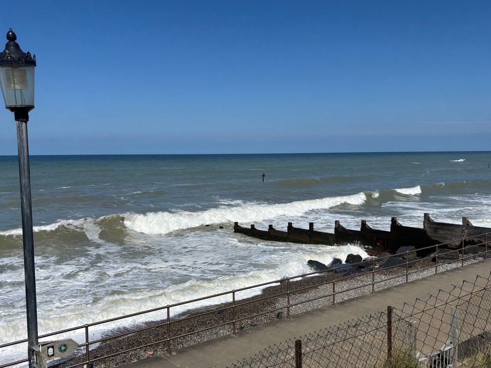 A view of the ocean and waves with a lamp post at Edal Court Sheringham