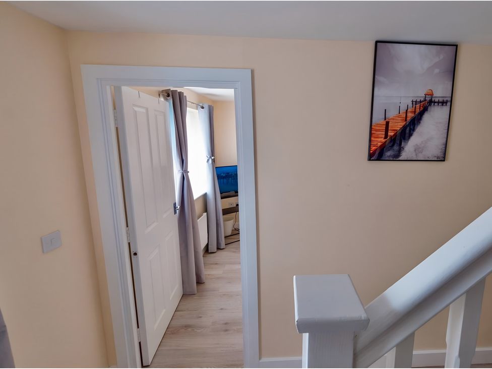 A hallway with a door and curtains at Rochester Road Corby