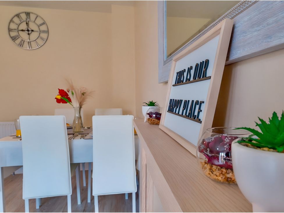 A dining room with a table set for dinner at Rochester Road in Corby
