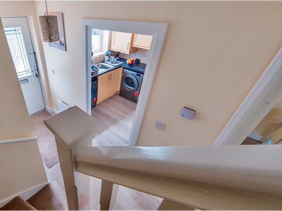 A hallway looking into a kitchen at Rochester Road in Corby